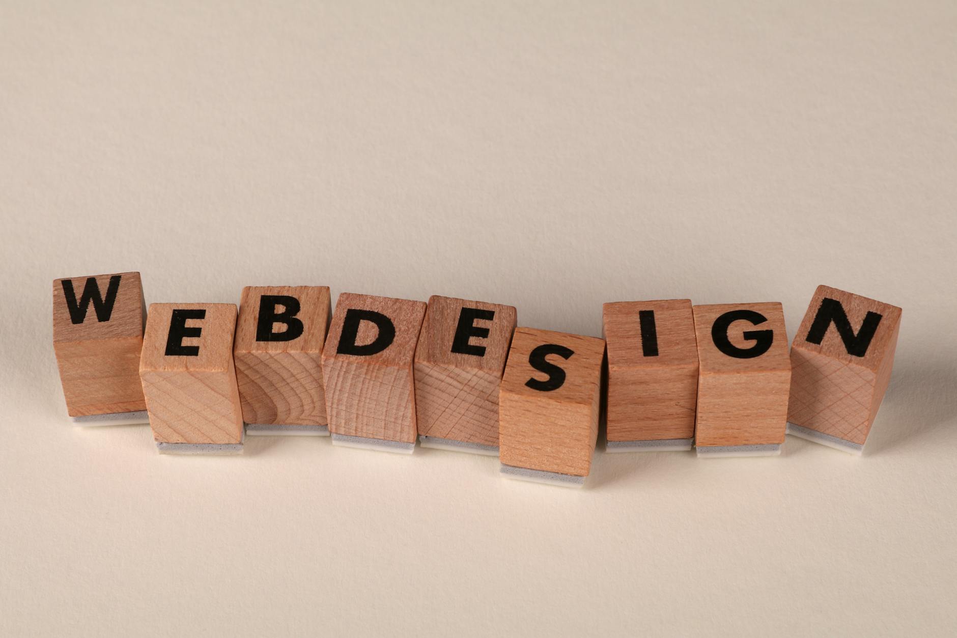 Wooden blocks spelling web design on a desk